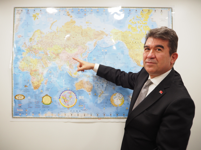 Turkish Ambassador to Korea Ersin Ercin points to the Middle East with which Turkey has had long historic, commercial, cultural, religious and ethnic ties. (Joel Lee/The Korea Herald)
