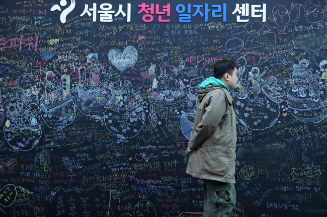 A pedestrian walks past a youth employment center in Seoul, Wednesday. (Yonhap)