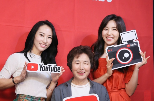 Housewife YouTubers Park Smi, Cho Seong-ja and Choi Seo-young pose for photos before a press event held Wednesday at Google Campus in southern Seoul. (KPR)
