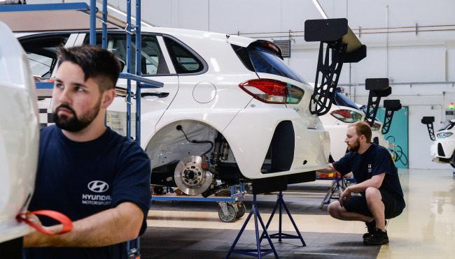 Engineers work on racing cars for WTCR competitions at Hyundai Motorsport’s workshop in Alzenau, Germany. (Hyundai Motor)