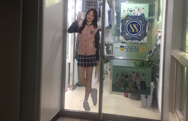 An uniform ad for school girls, featuring a short skirt, displayed in front of a shop in Seoul. (Claire Lee/ The Korea Herald)