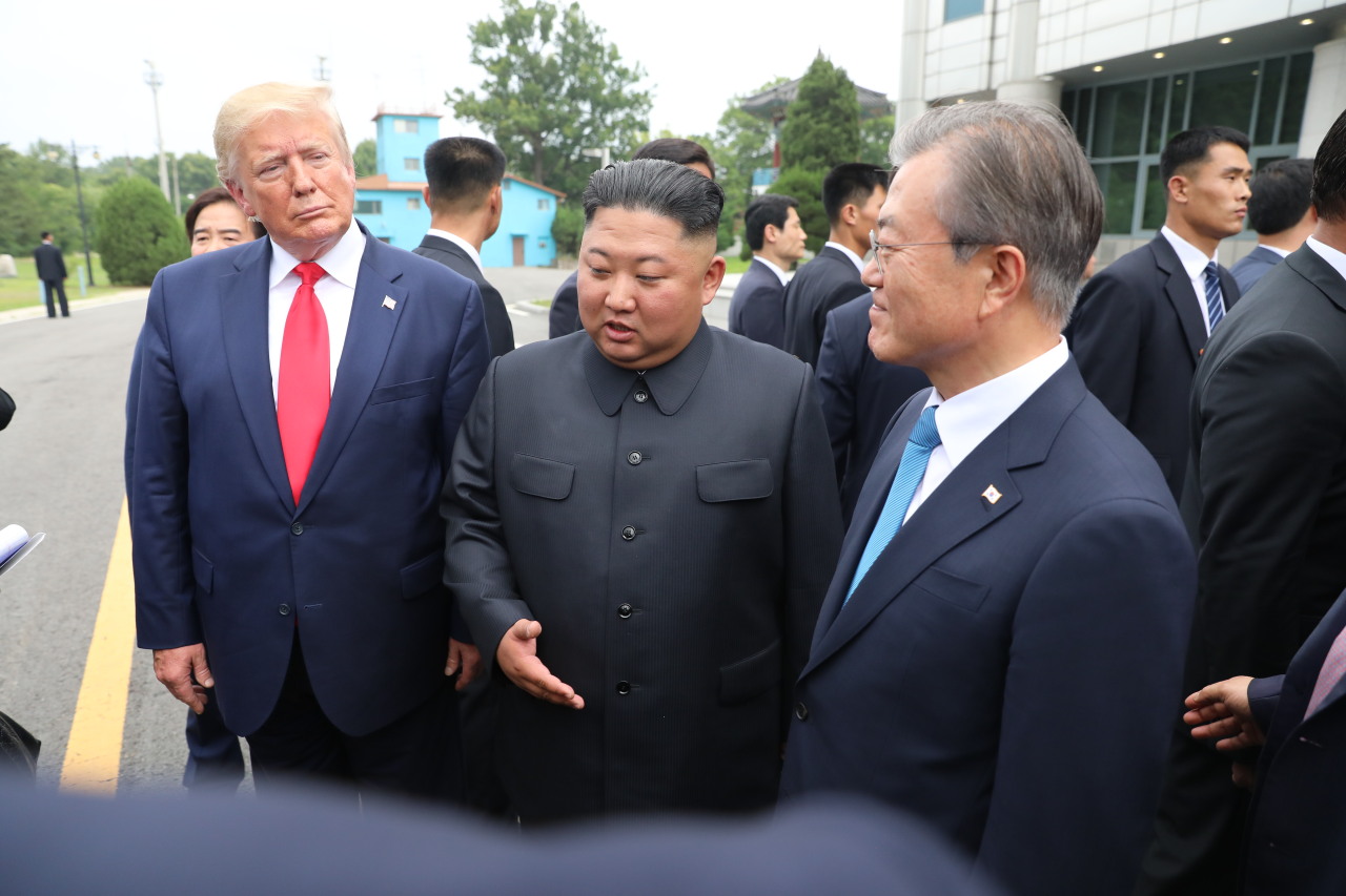 President Moon Jae-in, US President Donald Trump and North Korean leader Kim Jong-un at Panmunjom on Sunday. (Yonhap)