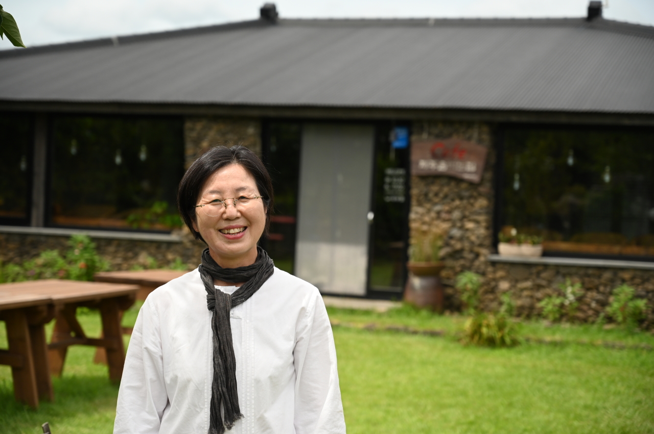 Kim Hee-sook poses for a photograph at her family-run Jeju Island Brewery in Seungeup Folk Village on Jeju Island on Aug. 9. (The Korea Herald)