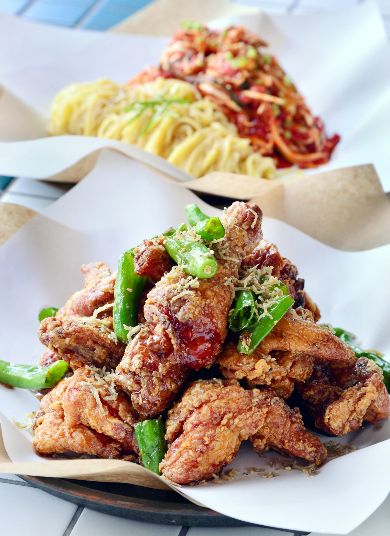 1) Hyodo’s chewy spicy noodles with dried pollack (back) acts as the perfect foil to crisp, piping hot chicken, including Hyodo’s popular soy sauce-based chicken (front). (Photo credit: Park Hyun-koo/The Korea Herald) 