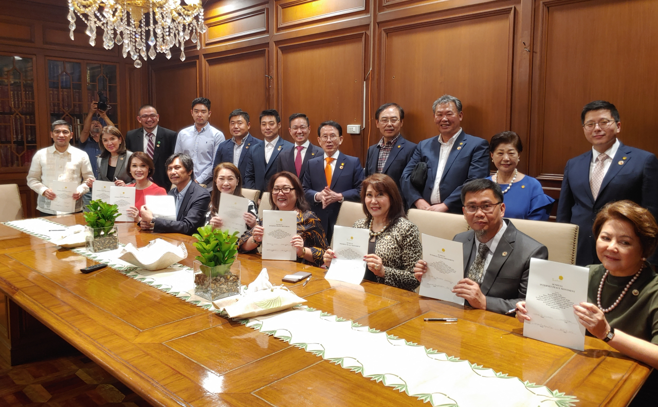 Members of the House of Representatives of the Philippines pose with Sunfull Foundation representatives at a signing event on Wednesday to mark the launch of the Sunfull Internet Peace Movement. (Sunfull Foundation)
