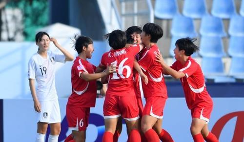 This photo provided by the Asian Football Confederation on Nov. 6, 2019, shows North Korean players (in red) celebrating their goal against South Korea in the semifinals of the AFC U-19 Women‘s Championship at Chonburi Stadium in Chonburi, Thailand. (Yonhap)