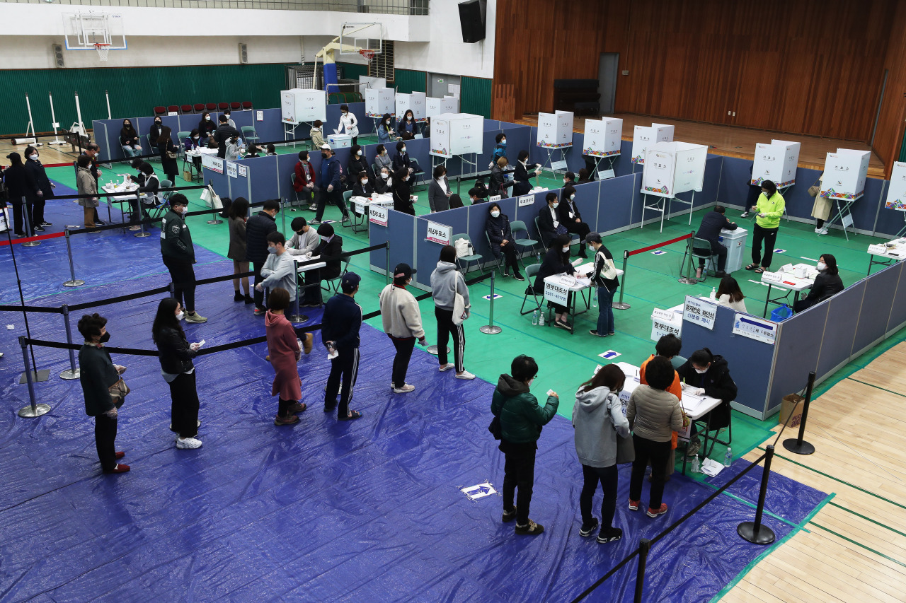 Voters line up at a polling station in Seoul on Wednesday. Yonhap
