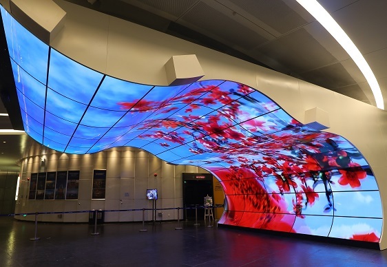 Organic light-emitting diode screens form curved display surfaces in commercial setting (LG Display)
