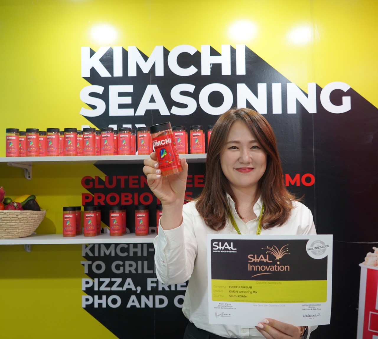 Sun An holds up her kimchi seasoning mix after winning an innovation award at a food expo in India in 2019. (Food Culture Lab)