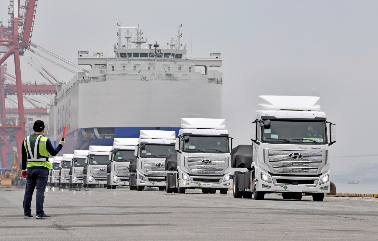 XCIENT trucks are moving to be loaded to a car carrier for export to Switzerland at Gwangyang Port, South Jeolla Province, on Monday. (Hyundai Motor Group)