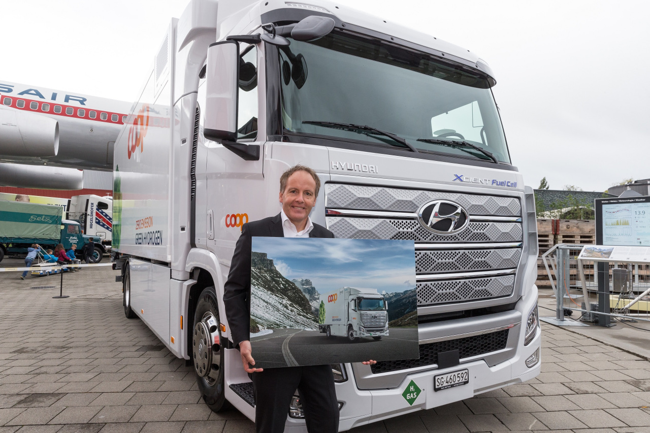 An official from Swiss retailer Coop poses in front of the Xcient Fuel Cell during the delivery ceremony in Lucerne, Switzerland, Wednesday. (Hyundai Motor)