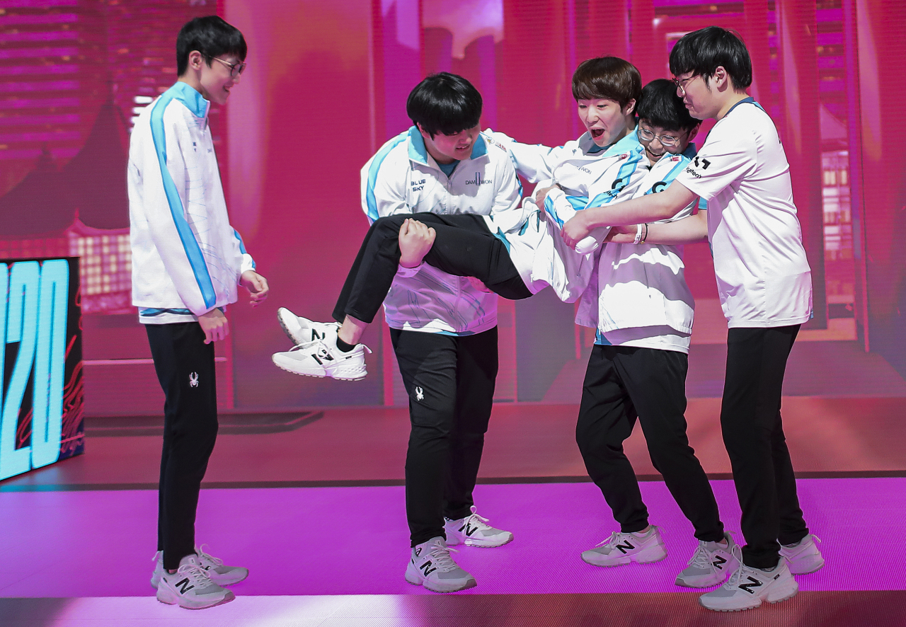 Players of Damwon Gaming celebrate after their win against G2 Esports on Saturday. (Riot Games)