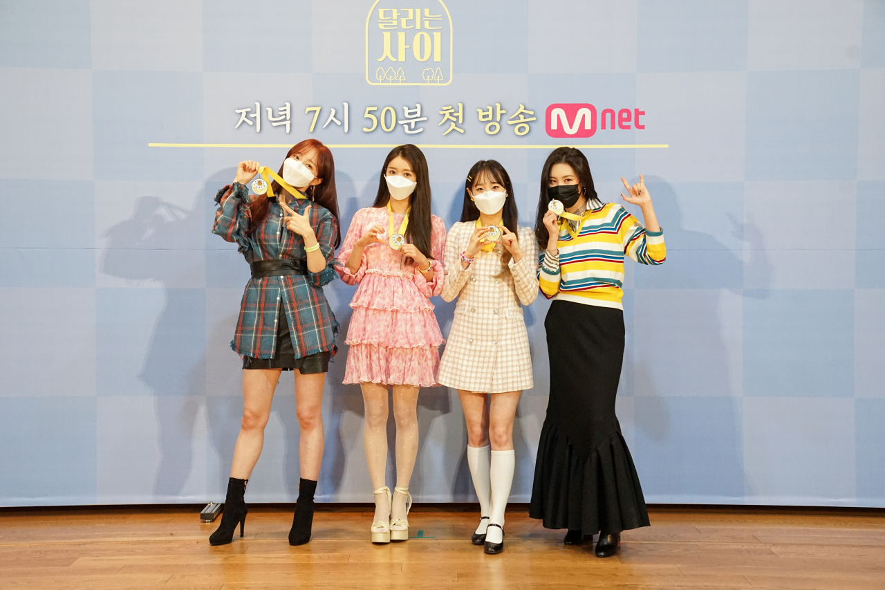 (From left) K-pop idols Hani (EXID), YooA (Oh My Girl), Chuu (Loona) and Sunmi pose before an online press conference for Mnet's “Running Girls” on Tuesday. (Mnet)