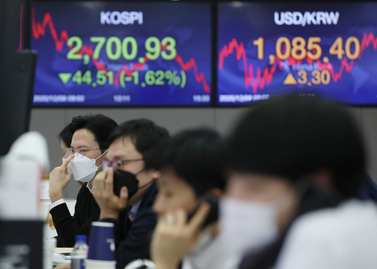 Electronic signboards at the trading room of Hana Bank in Seoul show the benchmark Kospi closed at 2,700.93 on Tuesday, down 44.51 points or 1.62 percent from the previous session's close. (Yonhap)