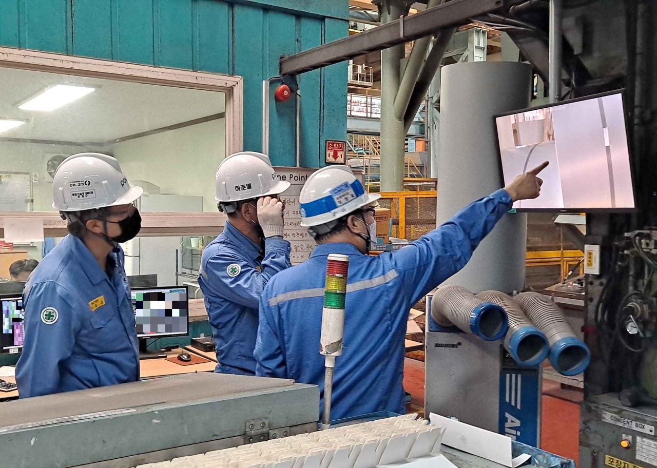 Posco employees examine a product identified by the company’s product recognition program. (Posco)