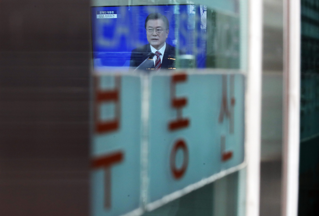 President Moon Jae-in is seen on the TV at a real estate agency in Seoul on Jan. 18, when he unveiled 2021 policy directions in a press conference at Cheong Wa Dae. (Yonhap)