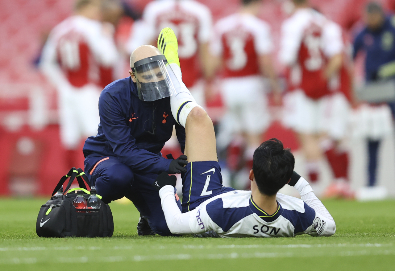 Tottenham`s Son Heung-min receives medical attention during the English Premier League soccer match between Arsenal and Tottenham Hotspur at the Emirates stadium in London, England on March 14. (AP-Yonhap)