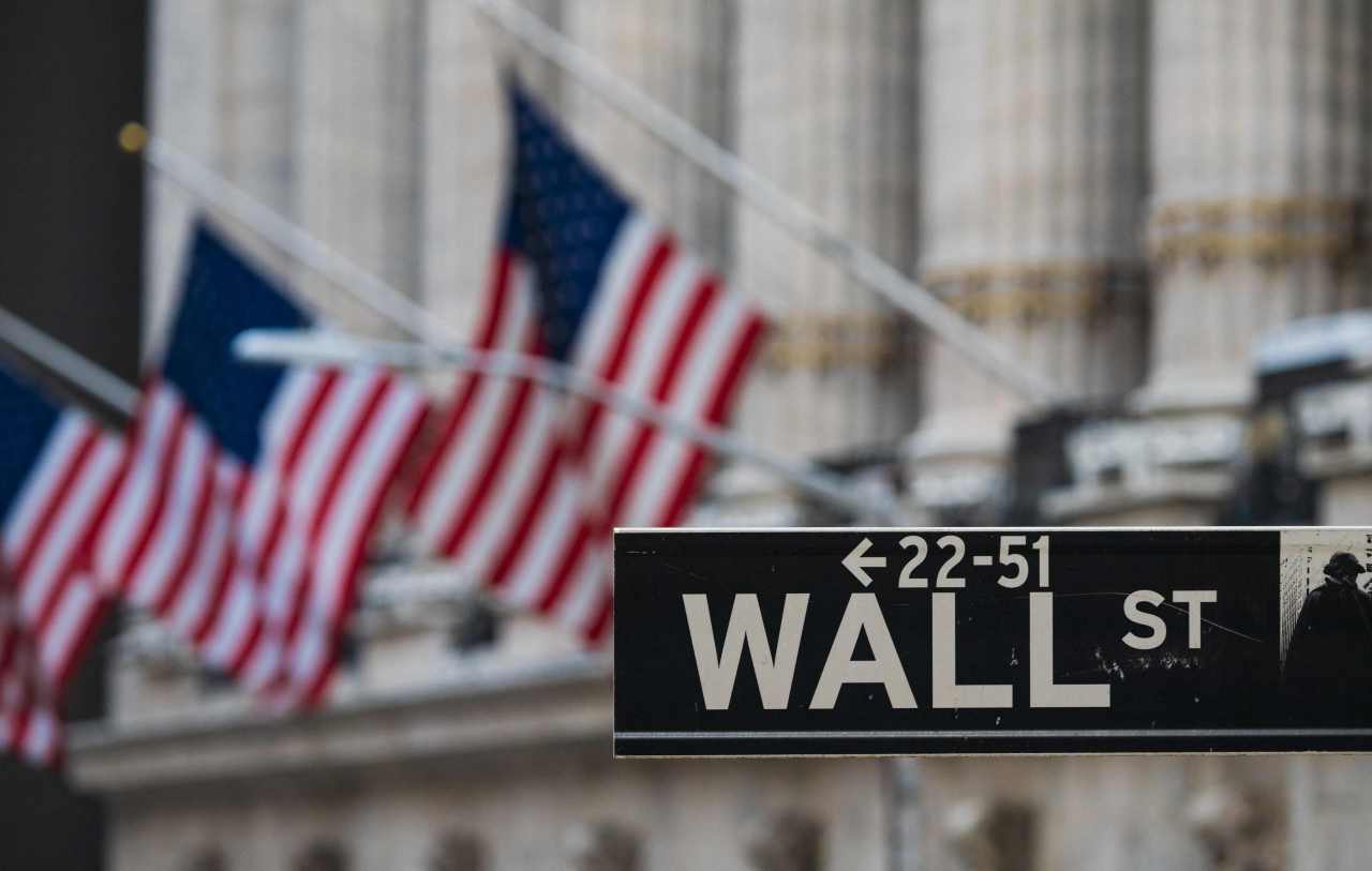 A sign for Wall Street hangs outside of the New York Stock Exchange in New York City. (AFP-Yonhap)