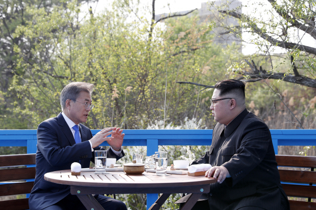 President Moon Jae-in (left) and North Korean leader Kim Jong-un talk at the border village of Panmunjeom on April 27 2018. (Cheong Wa Dae)