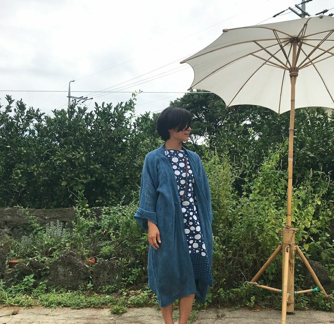 Fashion designer Kim Ji-young wears a naturally-dyed robe that she made with eco-friendly fabrics. (Courtesy of Kim)