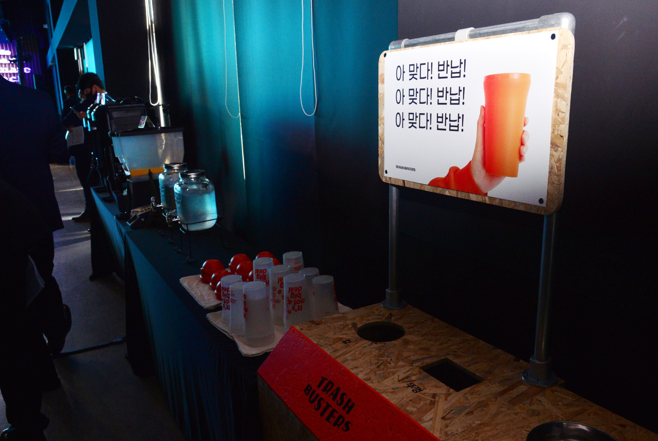 Reusable eco-friendly cups from Trash Busters are displayed at the venue. (Park Hyun-koo/The Korea Herald)