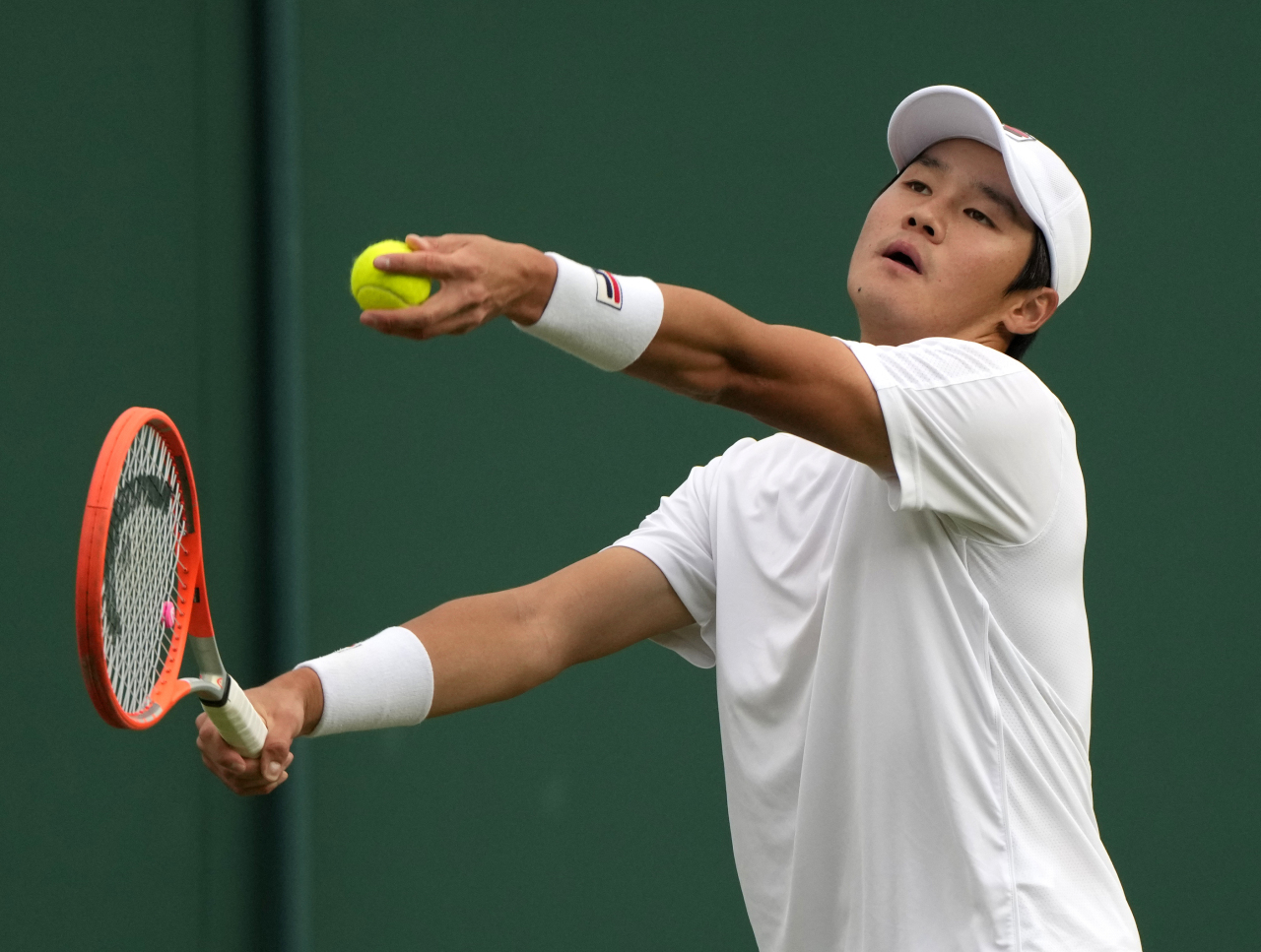 In this Associated Press photo, Kwon Soon-woo of South Korea hits a return to Daniel Masur of Germany during their men's singles match at Wimbledon at the All England Club in London on Monday. (AP-Yonhap)