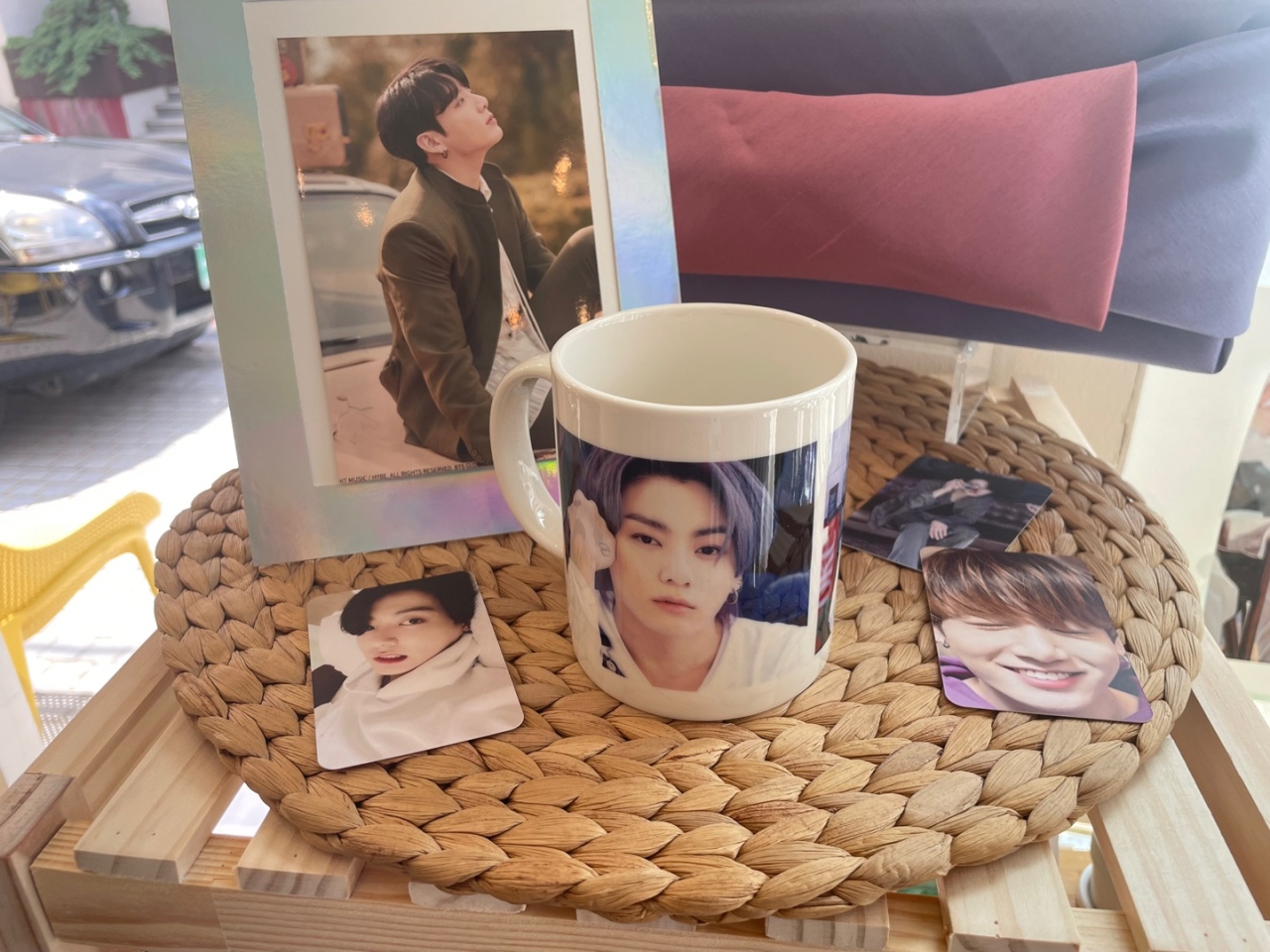 A mug, photo frame, and cards are displayed on a side table to celebrate Jung-kook’s birthday. (Kweon Ha-bin/The Korea Herald)