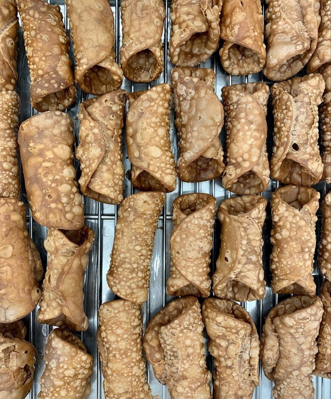 At Punto Dolce, the dough for cannoli is crafted using traditional ingredients like Marsala wine and cinnamon, before being shaped into dainty tubes and deep-fried. (Photo credit: Soojoo Kim)