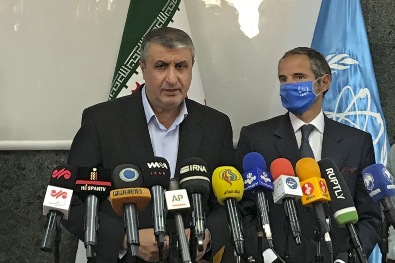 A handout picture provided by Atomic Energy Organization of Iran (AEOI) on Sunday shows head of the AEOI Mohammad Eslami delivering a speech next to Director General of the International Atomic Energy Agency (IAEA) Rafael Grossi (right) following their meeting in Tehran. (AFP-Yonhap)