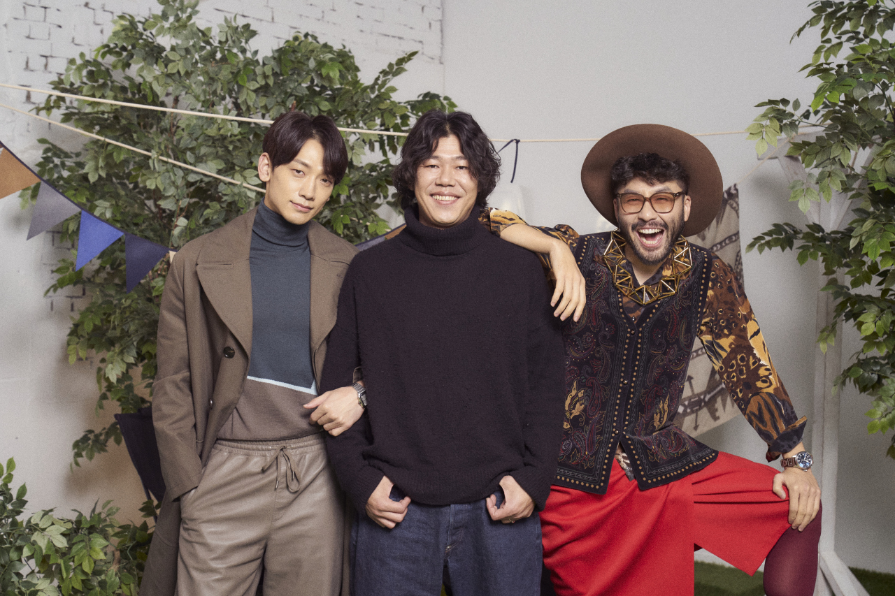From left: Singer Rain, music director Lee Sang-soon and television celebrity Ro Hong-chul pose for photos after an online press conference Wednesday. (Netflix)