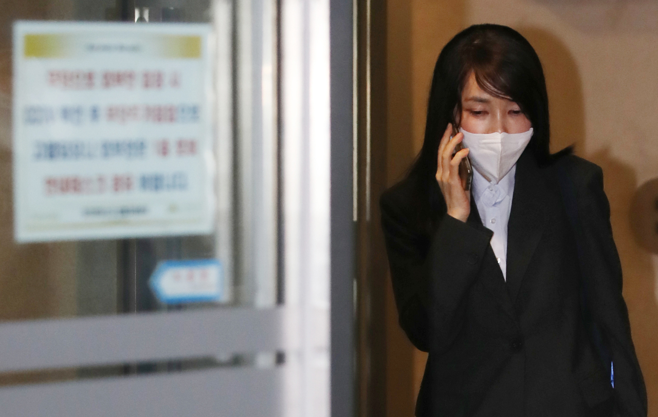 Kim Keon-hee, wife of the main opposition People Power Party's presidential candidate, Yoon Suk-yeol, makes a phone call as she leaves her residence in Seoul on Dec. 15, 2021, to head to her office. (Yonhap)