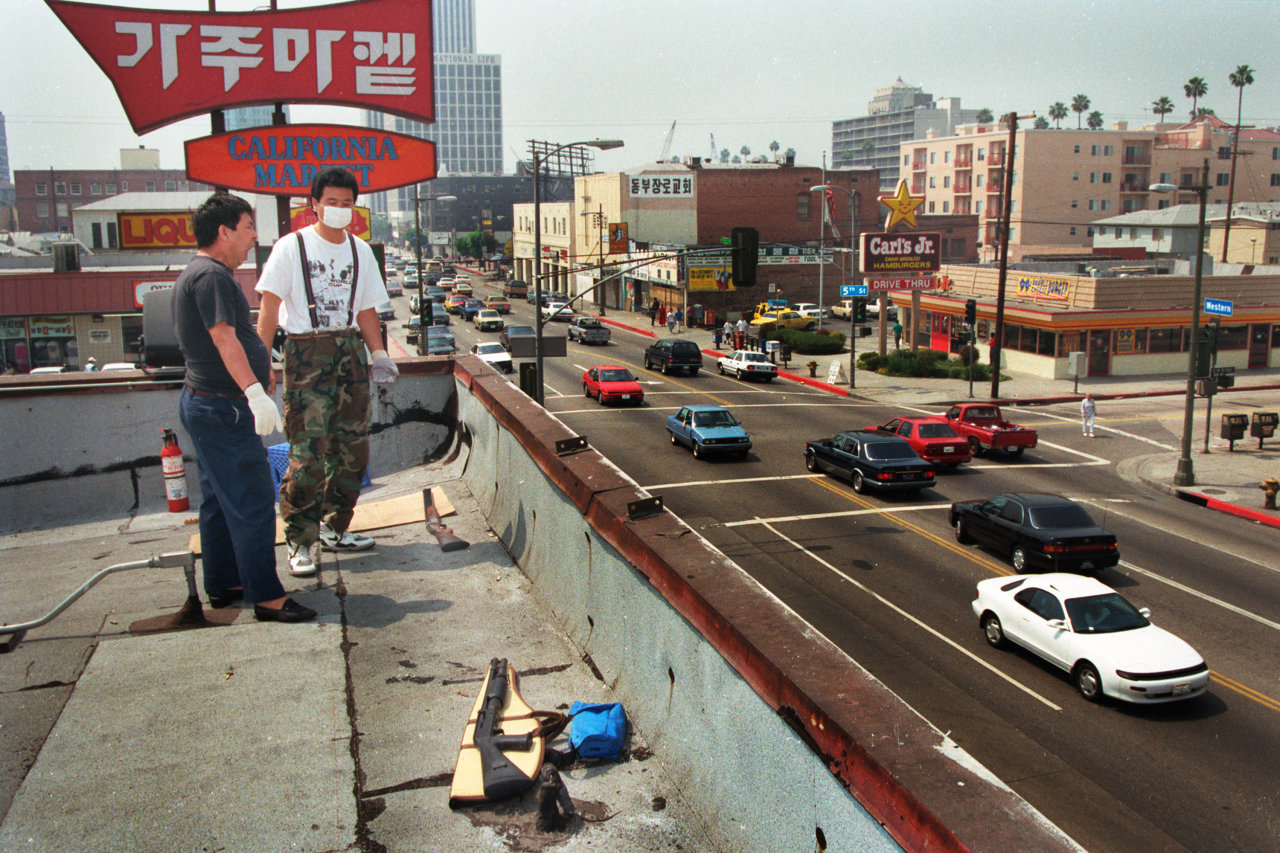 “Rooftop Koreans” guard California Market in Los Angeles, on May 1, 1992, the third day of the LA riots. (Hyungwon Kang)