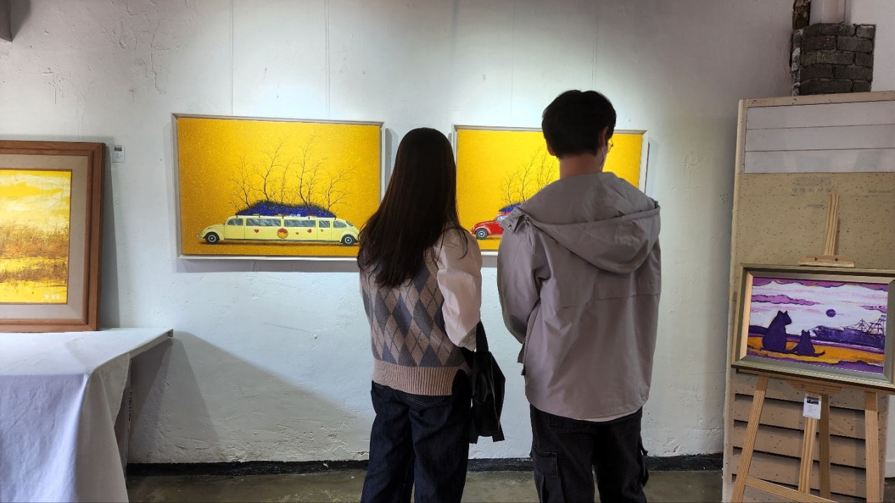 Visitors look at the artworks on display at the Artfield Gallery in the Mullae Creative Village, southwest of Seoul (Artfield Gallery)