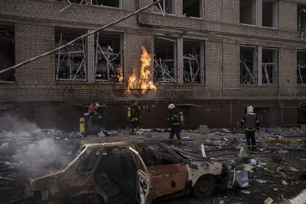 Firefighters work to extinguish multiple fires after a Russian attack in Kharkiv, Ukraine, Saturday. (AP Photo/Felipe Dana)