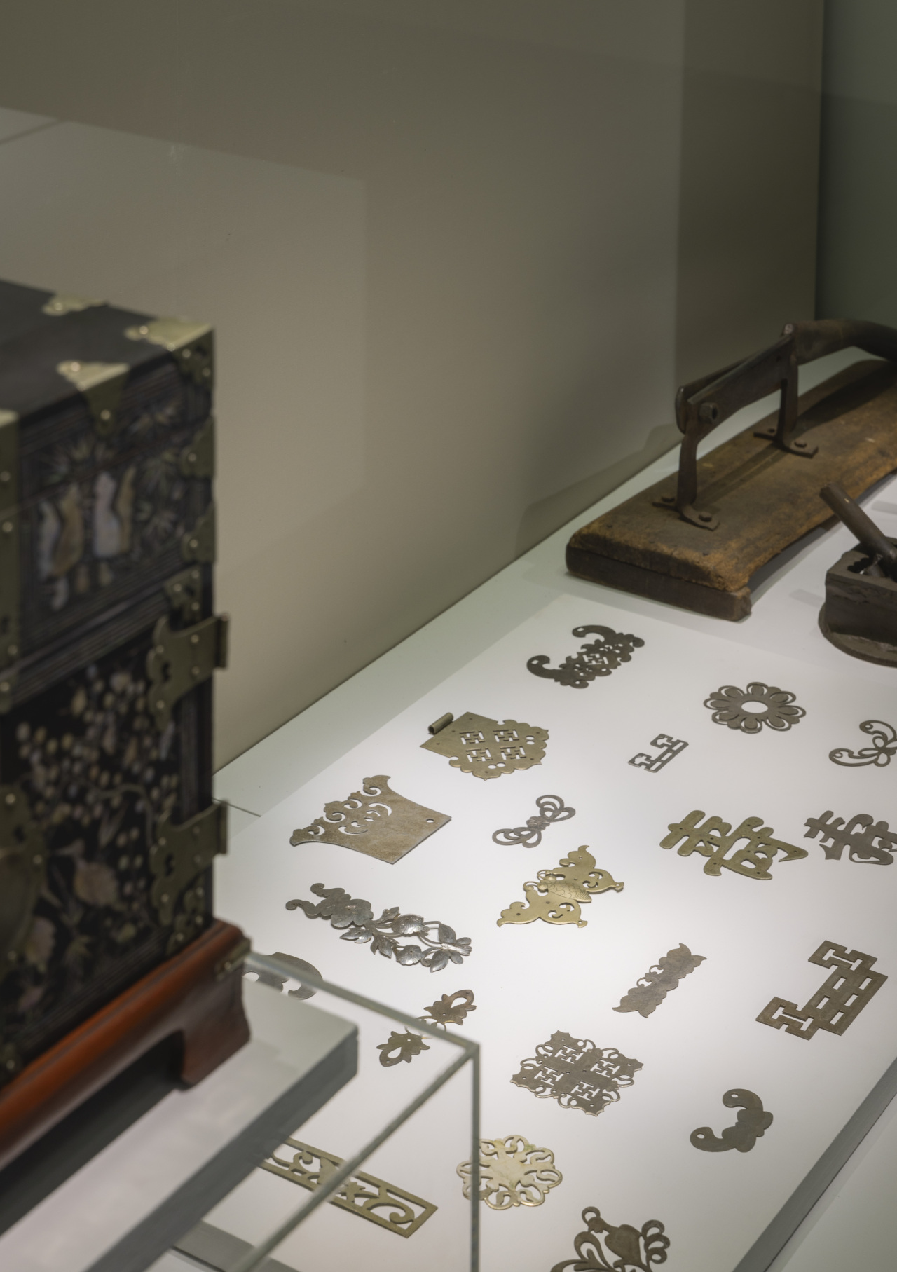 Metal ornamental decorations used for wooden furniture are on display at “Hands to Art; Inspired by 12 Studios” at Tongyeong City Museum. (Tongyeong Triennale)