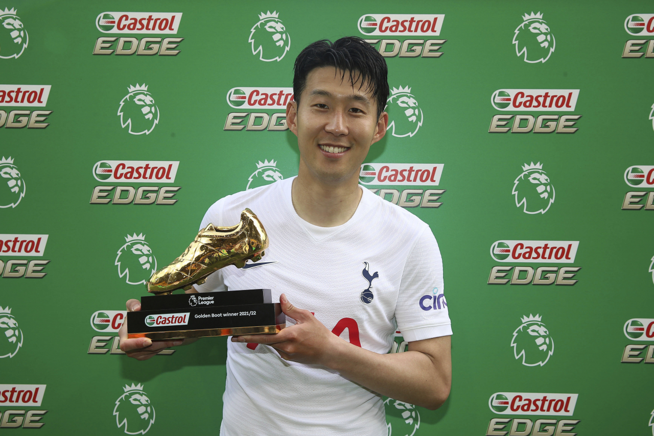 In this Press Association photo via Associated Press, Son Heung-min of Tottenham Hotspur poses with the Golden Boot award after sharing the goals scoring lead in the Premier League with Mohamed Salah of Liverpool, following Tottenham's 5-0 victory over Norwich City at Carrow Road in Norwich, England, on Sunday. (Associated Press)