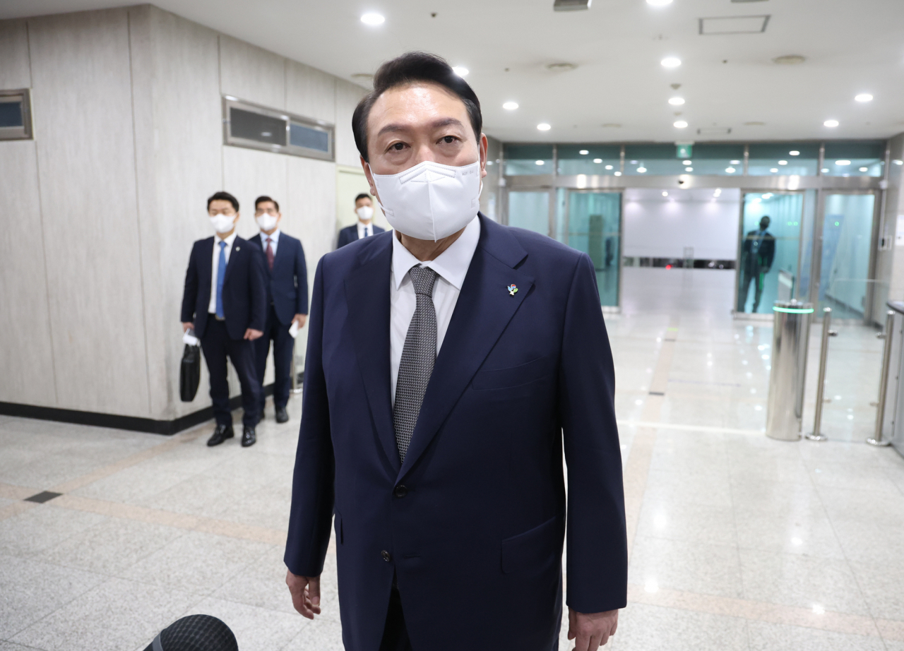 President Yoon Suk-yeol speaks to reporters as he arrives for work at the presidential office in Seoul's central district of Yongsan on Friday. (Yonhap)