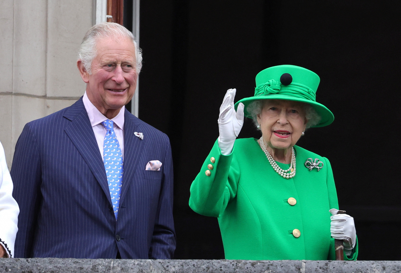 Britain's Queen Elizabeth and Prince Charles stand on the balcony during the Platinum Pageant, marking the end of the celebrations for the Platinum Jubilee of Britain's Queen Elizabeth, in London on Sunday. (AFP)