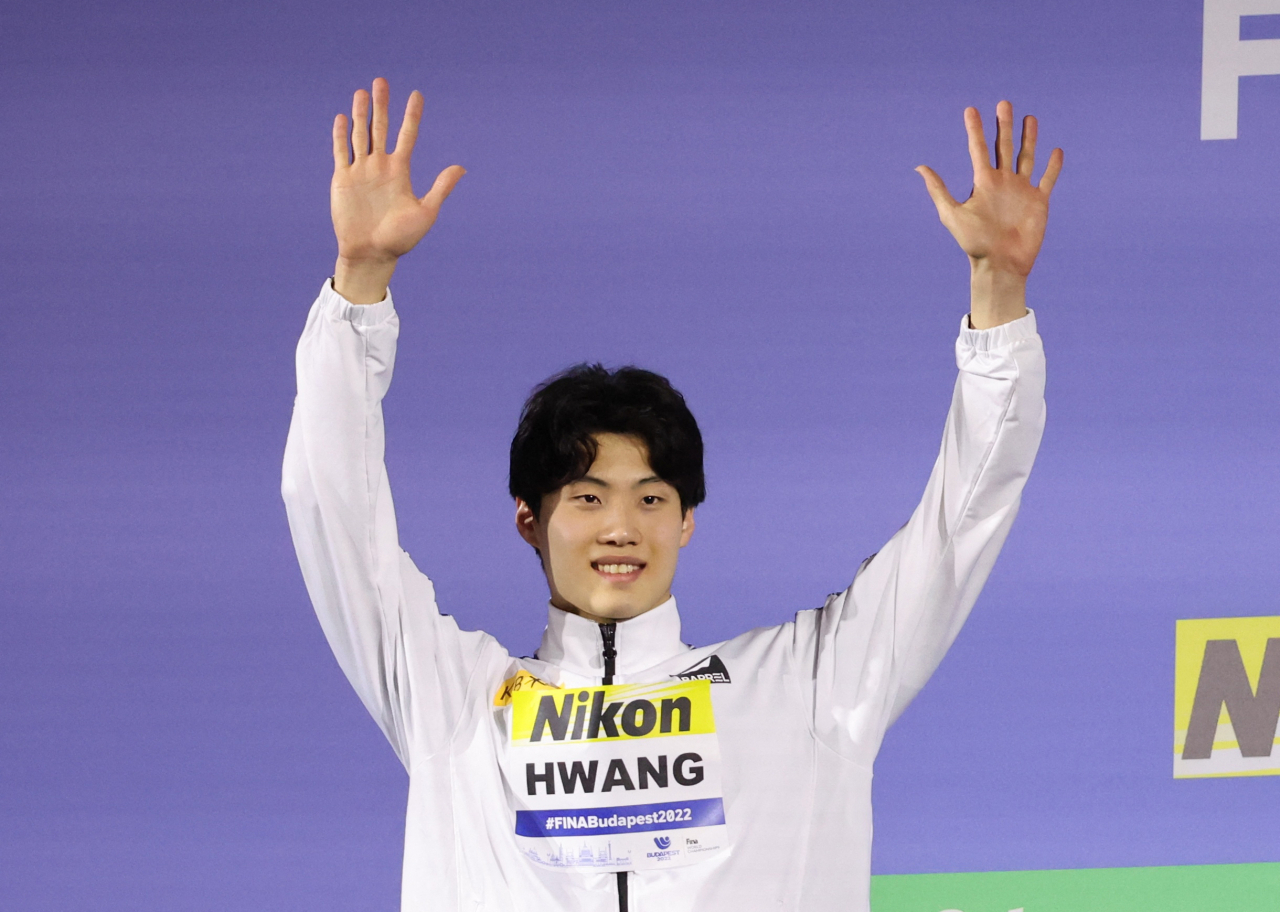 In this Reuters photo, Hwang Sun-woo of South Korea celebrates on the podium after winning silver in the men's 200m freestyle at the FINA World Championships at Duna Arena in Budapest on Monday. (Reuters)