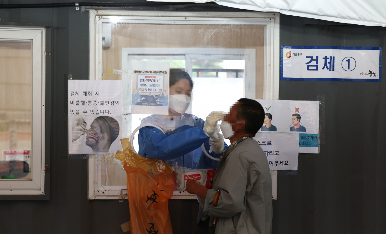 A man gets tested for the coronavirus at a testing center near Seoul Station on June 29, 2022. (Yonhap)