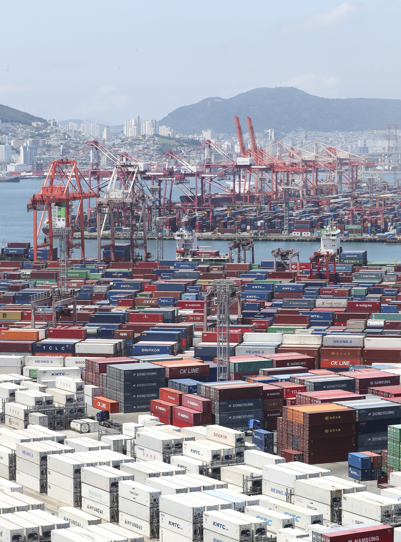 Containers for exports and imports are stacked at a pier in South Korea's largest port city of Busan last Friday. South Korea logged a trade deficit of $10.3 billion in the January-June period, the highest figure for any first-half period, due to high global energy prices, according to data from the Ministry of Trade, Industry and Energy. (Yonhap)