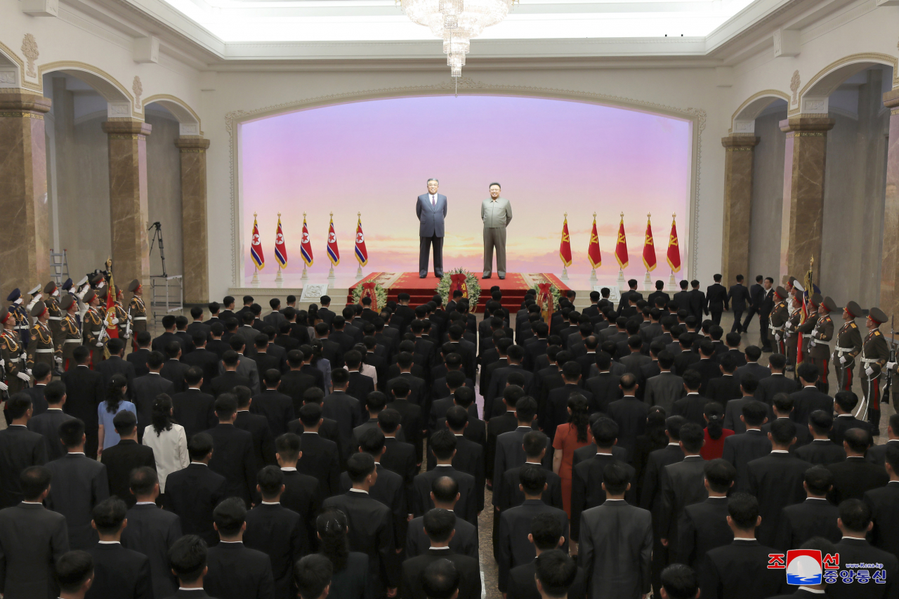 This photo released on Friday by North Korea's official Korean Central News Agency shows the North's leader Kim Jong-un and other officials visiting the Kumsusan Palace of the Sun in Pyongyang to pay tribute to his grandfather and North Korea's founder, Kim Il-sung, as the communist country marks the 28th anniversary of the former leader's death the same day, in this photo released by the North's official Korean Central News Agency. The mausoleum enshrines the mummified bodies of Kim Il-sung and Kim Jong-il, the current leader's father. (Yonhap)
