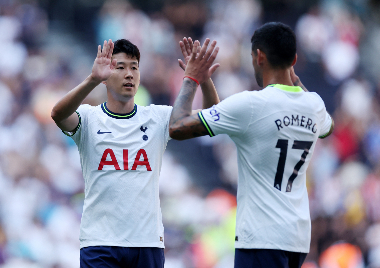 In this Action Images photo via Reuters, Son Heung-min (L) and Cristian Romero of Tottenham Hotspur celebrate their 4-1 victory over Southampton in a Premier League match at Tottenham Hotspur Stadium in London on Saturday. (Reuters)