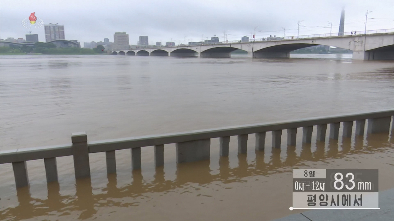 A riverside pathway in Pyongyang by the Taedong River that runs through the capital is submerged on Monday, in this captured footage from the North's Korean Central Television. (North's Korean Central Television)