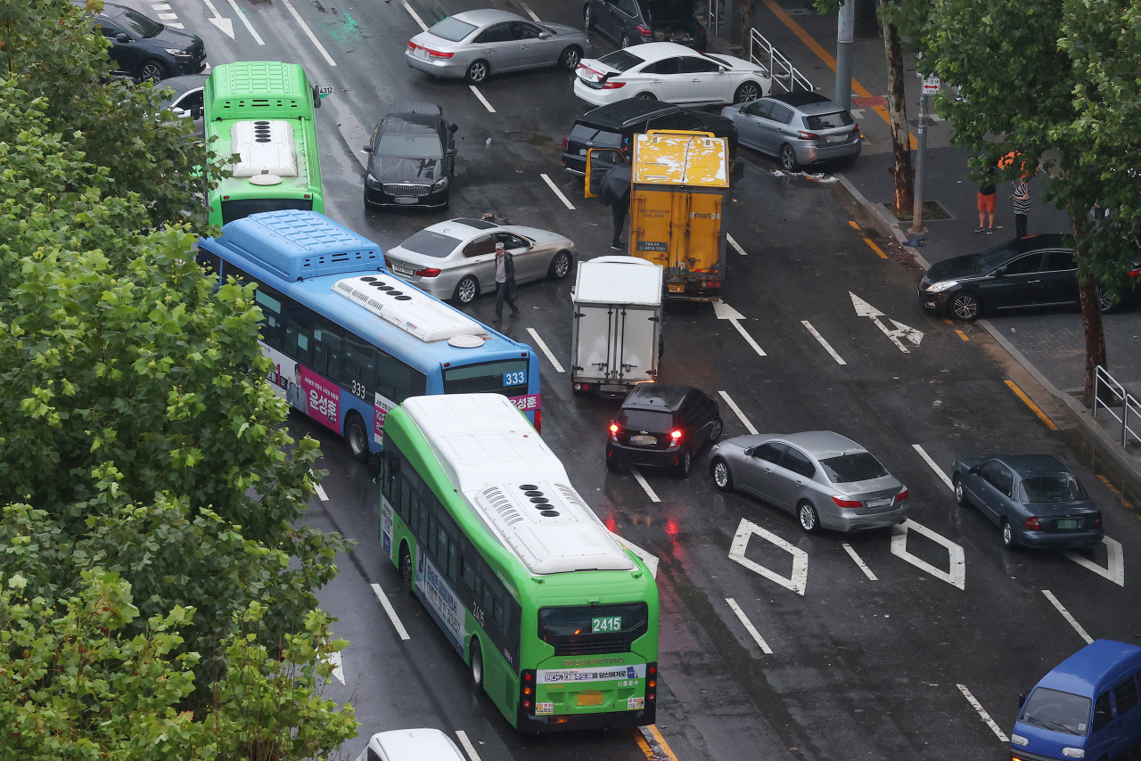 Cars abandoned Monday due to flooding remain stranded on Tuesday morning on the roads of Gangnam, southern Seoul. (Yonhap)
