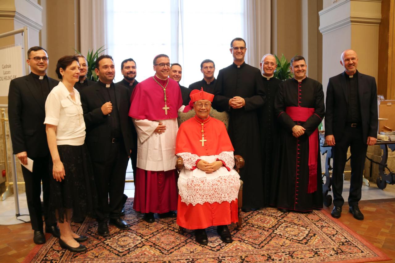 Archbishop Lazzaro You Heung-sik, sitting in the middle, poses for photos with staff members of the Congregation for Clergy on Saturday after being appointed as one of 20 new cardinals in Vatican. (Yonhap)
