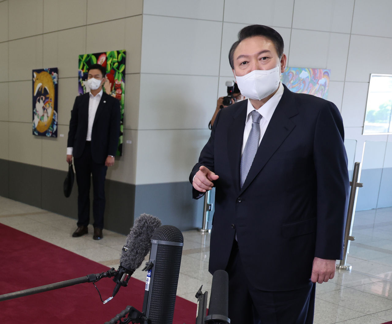 President Yoon Suk-yeol takes reporters' questions as he arrives for work at the presidential office in Seoul on Thursday. (Yonhap)
