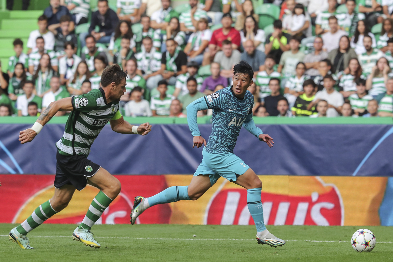 In this EPA photo, Son Heung-min of Tottenham Hotspur (right) tries to hold off Sebastian Coates of Sporting during the clubs' Group D match in the UEFA Champions League at Jose Alvalade Stadium in Lisbon on Tuesday. (EPA)