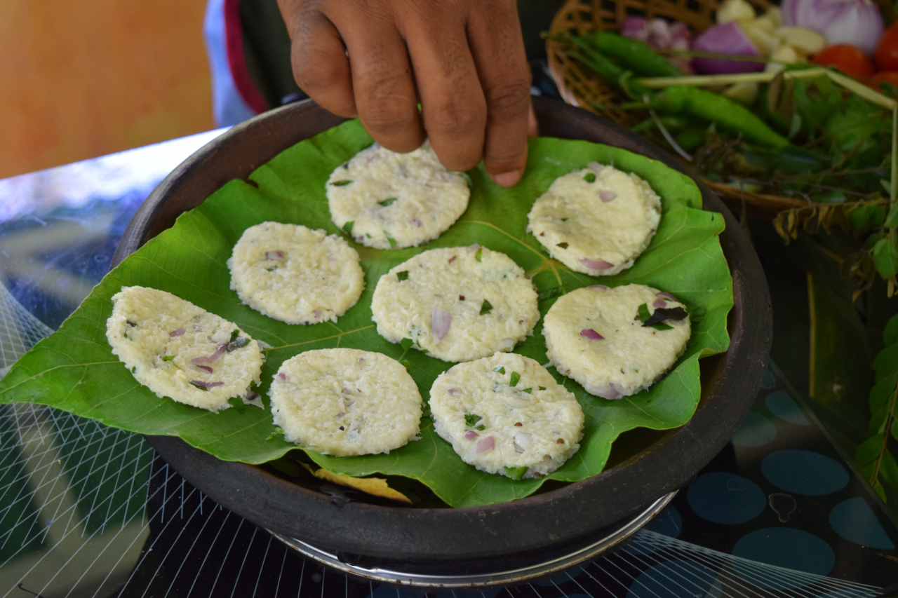 Mounds of coconut flatbread dough, also known as Pol roti, are placed in a pan. (Kim Hae-yeon/ The Korea Herald)