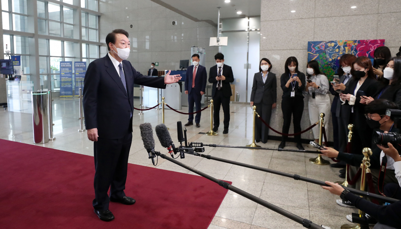 President Yoon Suk-yeol answers reporters' questions while arriving for work at the presidential office in Seoul on Tuesday. (Yonhap)